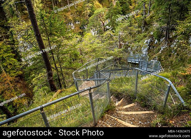 Descending stairs with railing in the so-called Leutascher Geisterklamm between Mittenwald and Leutasche in the border area between Austria and Germany