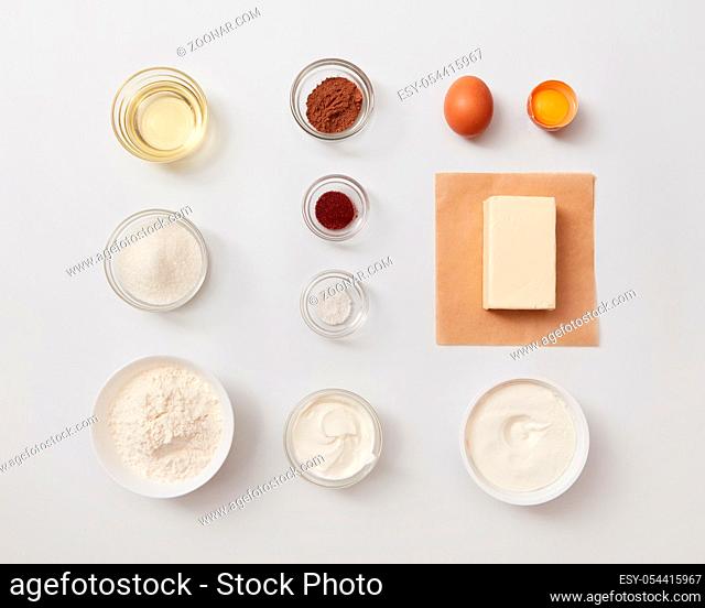 Top view of different ingredients for baking or cooking represented separately over white background. Ingredients for cooking cakes or breads