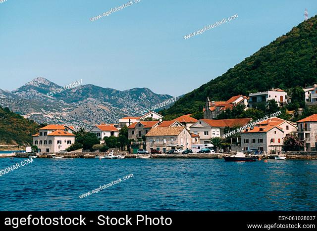The coastline of the city of Lepetane in Chernogoria, near the ferry crossing through Kotor Bay. High quality photo
