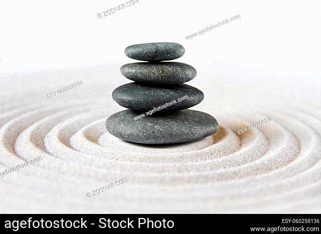 Black stones pile in the sand. Zen japanese garden background scene