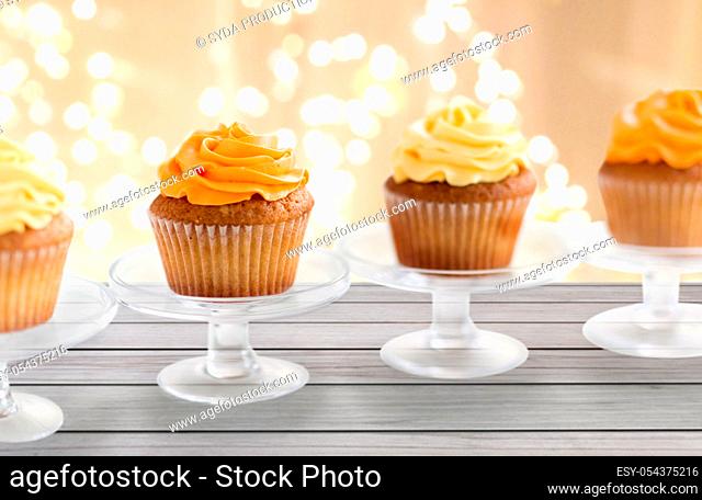 cupcakes with frosting on confectionery stands