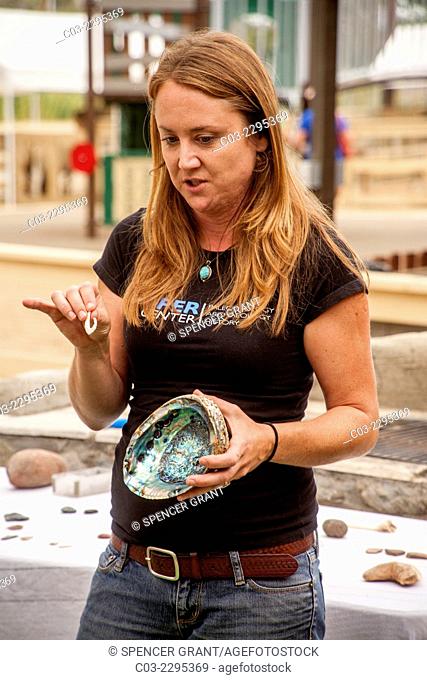 An anthropology museum curator shows an abalone shell and a fish hook made of shell as she lectures to a youth group on the Juaneno Indian Tribe in San Juan...
