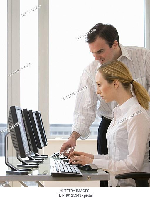 Businesspeople looking at computer