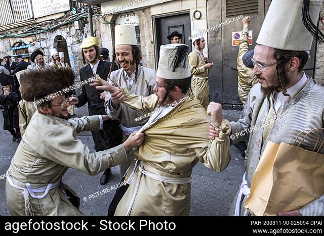dpatop - 11 March 2020, Israel, Jerusalem: Ultra orthodox Jewish men in traditional attires take part in celebrations at Jerusalem's Mea She'arim neighbourhood...