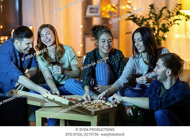 friends eating pizza and drinking wine at home
