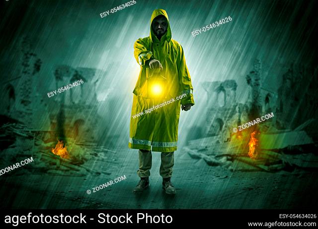 Destroyed place after a catastrophe with man in raincoat and lantern concept