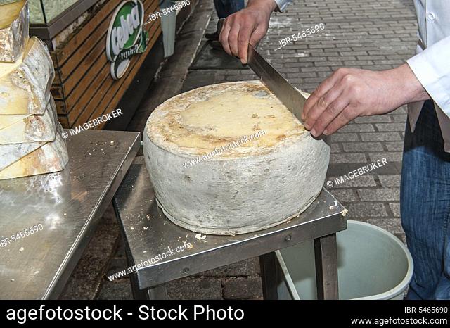 Man prepares cheese, bazaar, Egyptian bazaar, spice bazaar, Istanbul, Turkey, Asia
