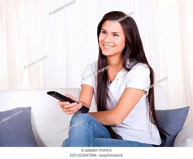 Smiling woman with a remote control