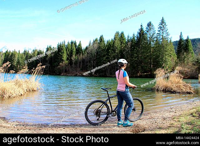 young woman riding mountain bike at Geroldsee in Buckelwiesen near Krün, Germany, Bavaria, Upper Bavaria, Isartal, road, path, bicycle