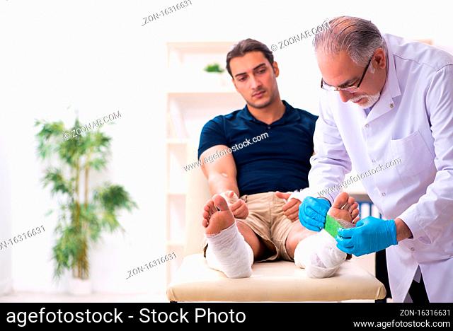 Young injured man visiting doctor traumatologist