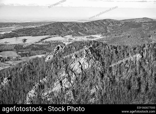 Oresnik granite rock formation in Jizera Mountains. Early spring time. Czech Republic. Black and white image