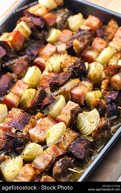 skewers with poultry meat, bacon and onion