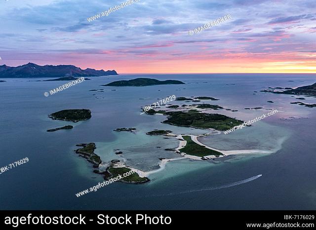 View of small islands in the sea near Sommarøy, mountains of Senja Island in the back, aerial view at sunset, Kvaløya, Troms og Finnmark, Norway, Europe