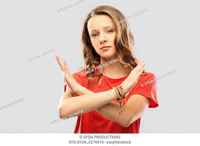 teenage girl crossing hands in forbidding gesture