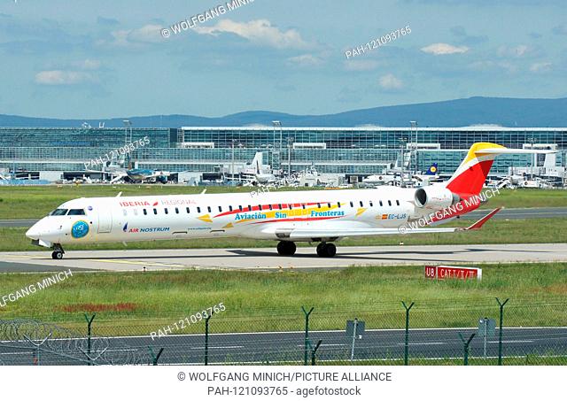 Frankfurt Rhein-Main Airport. Frankfurt Airport. A Bombardier CRJ 900 of the Spanish airline Iberia - Air Nostrum, on a taxiway to a parking position on the...