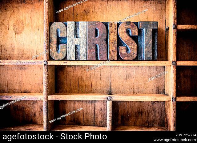 The word CHRIST written in vintage wooden letterpress type in a wooden type drawer