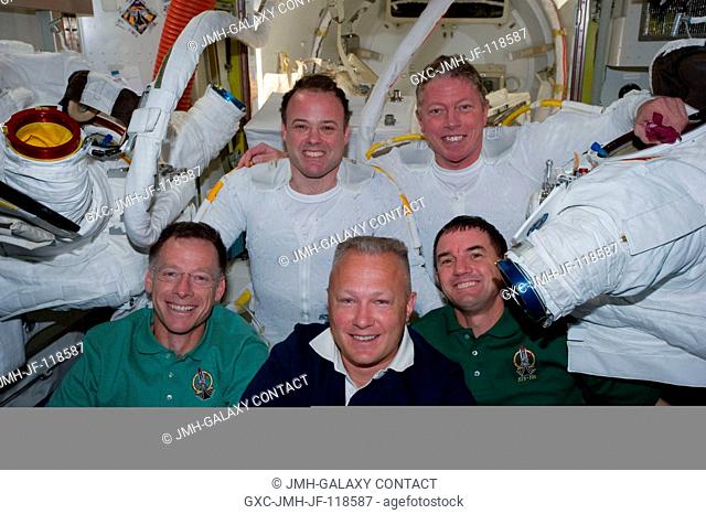 Following the six-hour, 31-minute spacewalk of NASA astronauts Ron Garan (top left) and Mike Fossum (top right), five members of the joint shuttle-station crew...