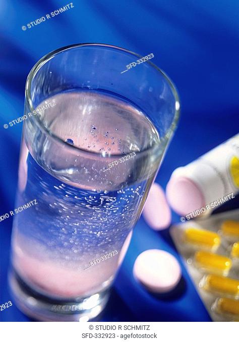 Vitamin tablets with a glass of water