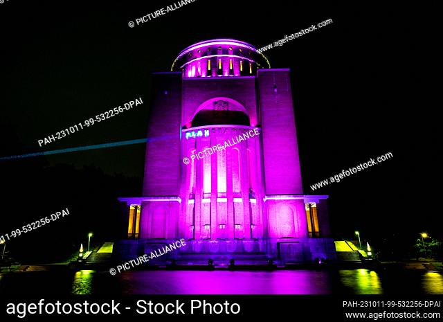 11 October 2023, Hamburg: The planetarium in the city park is lit up in pink during a campaign by the ""Plan International"" organization for World Girls' Day