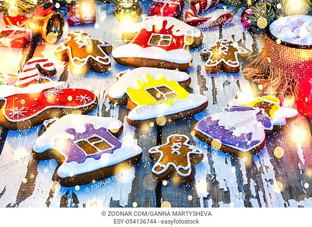 Christmas gingerbread. Christmas baking on a wooden background with burning candles