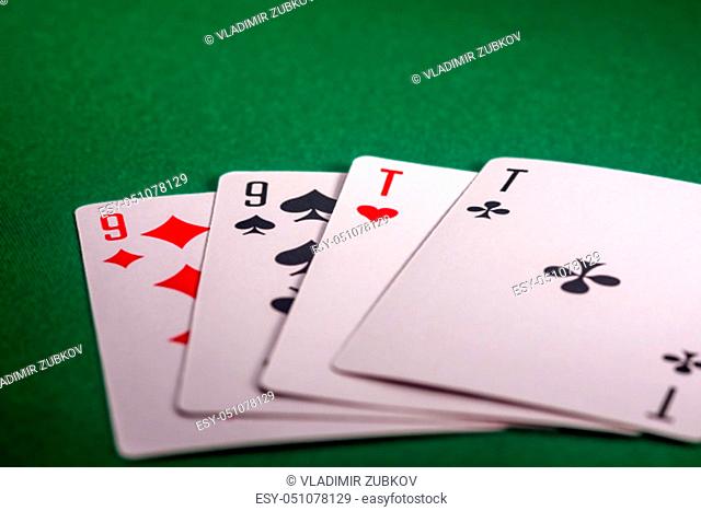playing cards on the green table. Combination ""Two pair"" in poker