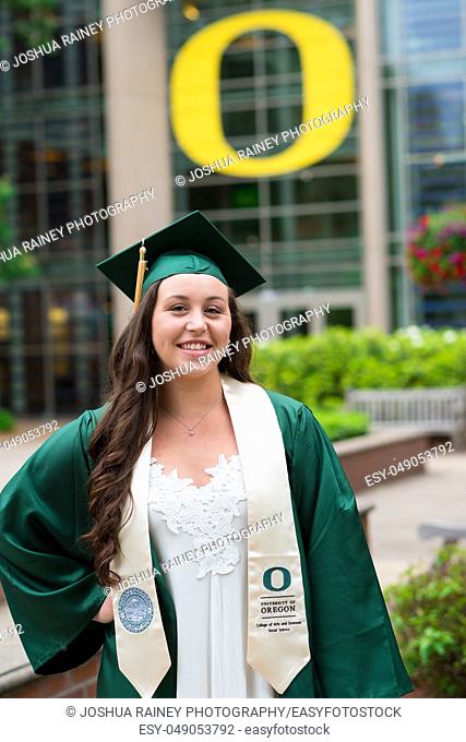 Eugene, OR - May 19, 2019: University of Oregon graduate Lacie Brown celebrates her graduation in cap and gown on campus in Eugene