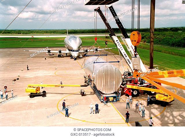 06/12/1999 -- At KSC's Shuttle Landing Facility SLF, overhead cranes are fitted around the S0 truss segment to move it onto a flatbed trailer which will...