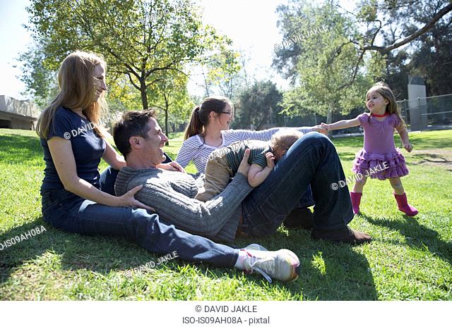 Happy family relaxing on grass