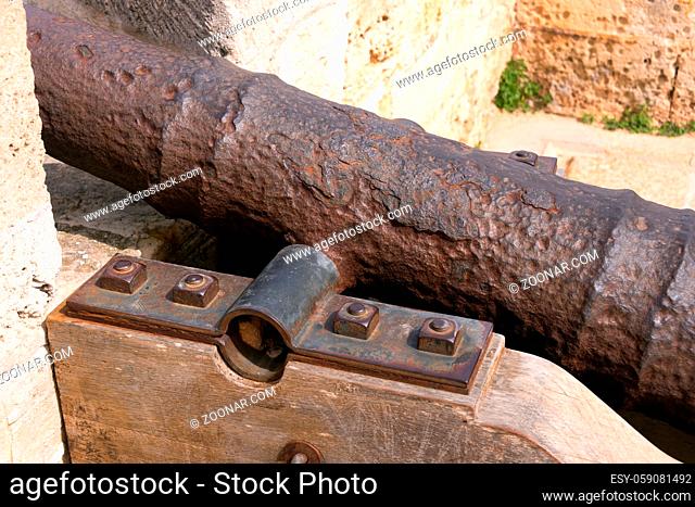 Close-up of an old antique iron cannon on the old defence tower of Punta de N'Amer near Sa Coma, on the Spanish Balearic Mediterranean island of Mallorca