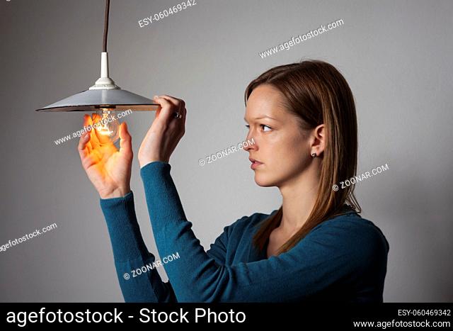 woman with a light bulb on white