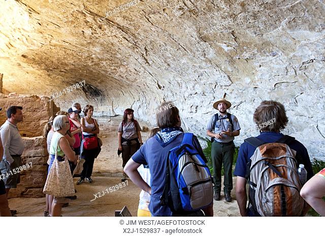 Cortez, Colorado - A park ranger talks to visitors touring the Long House cliff dwelling in Mesa Verde National Park  The park features cliff dwellings of...