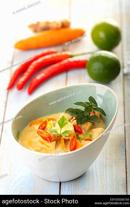thai tom kha gai soup on wood
