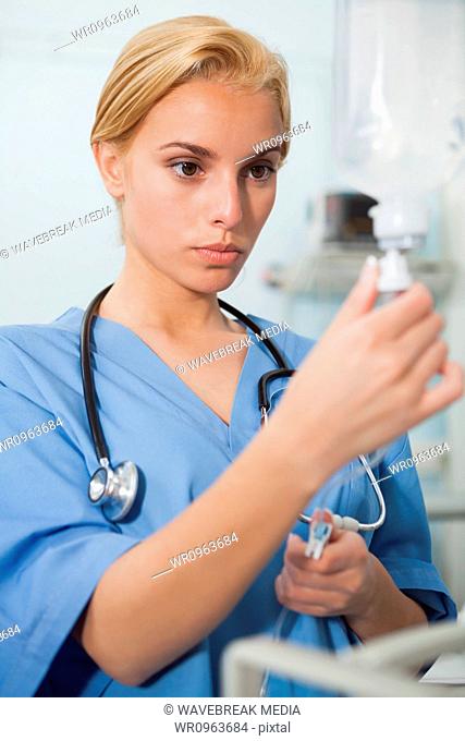 Nurse looking at an intravenous drip