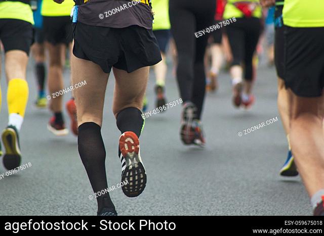 Athletes, runners at the marathon, athletes ' legs rear view