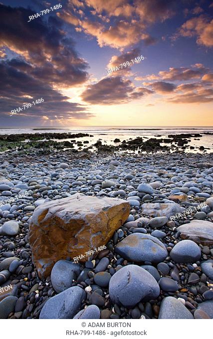 Sunset over the Atlantic from the pebbly shores of Sandymouth, Cornwall, England, United Kingdom, Europe