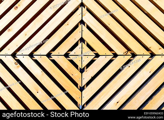Symmetrical diamond background pattern with natural wood in concentric squares or rectangles viewed from above