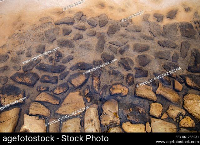 Background with flat stones, mud and water
