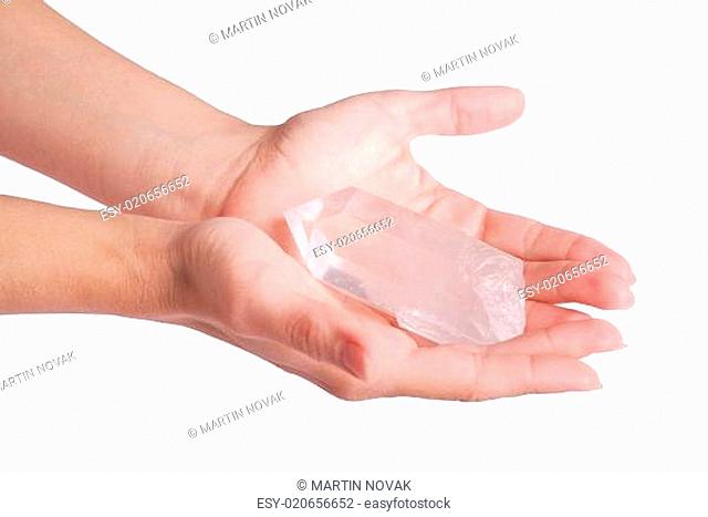 Hands offering quartz crystal