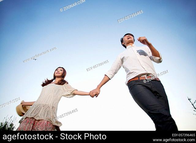Young couple walking hand in hand high quality photo