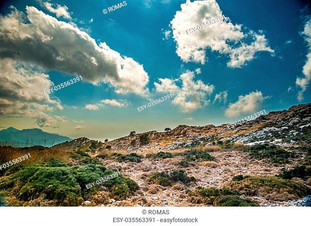 Beautiful landscape with rocky mountains and clouds on the western part of Mallorca island, Spain. Tramuntana mountains with green bushes