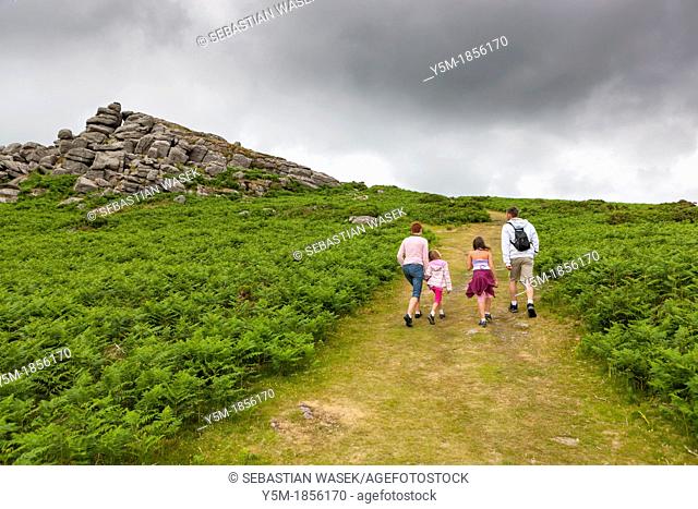 Family walking up Bell Tor in the Dartmoor National Park, near Widecombe in the Moor, Devon, England, UK, Europe