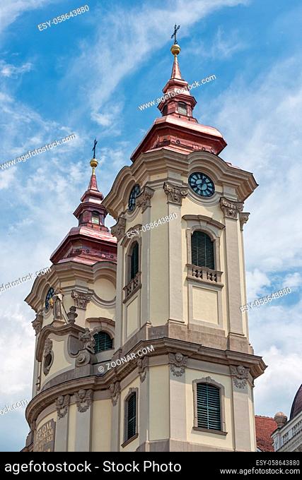 Two clock towers of Minorite church at Eger main square in Hungary