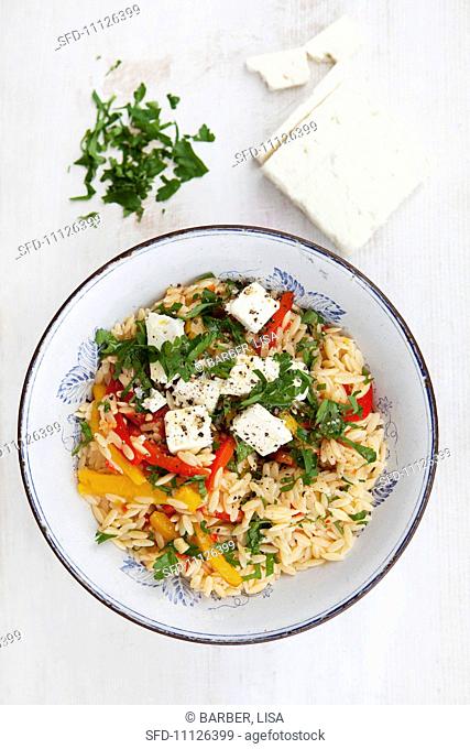 Rice pasta with vegetables and feta cheese