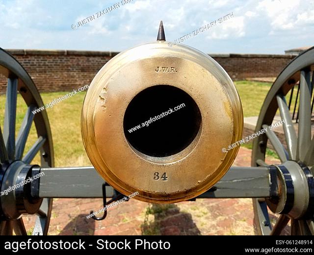large brass cannon on wheels with JWR and 34 on it