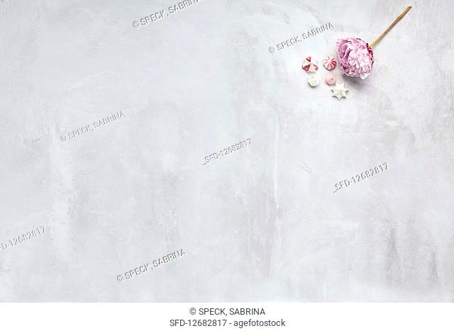 Meringues and a flower on a white surface