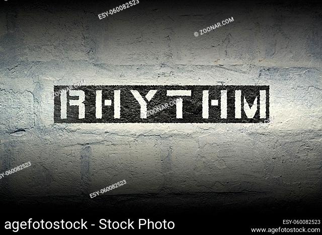 rhythm word stencil print on the grunge white brick wall