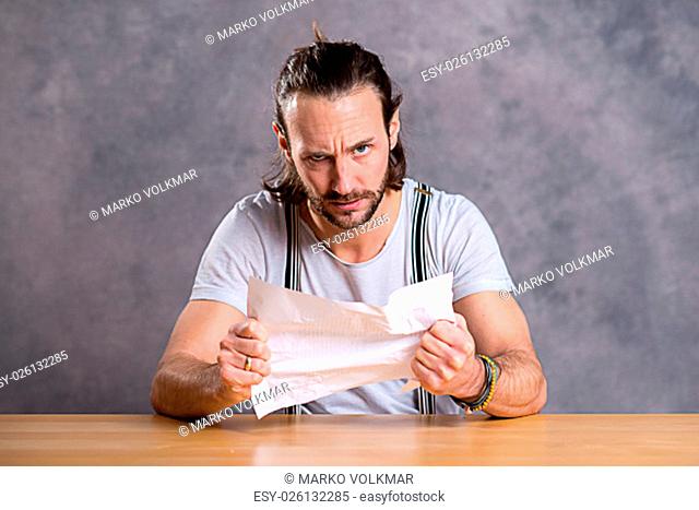 young man is annoyed about a letter