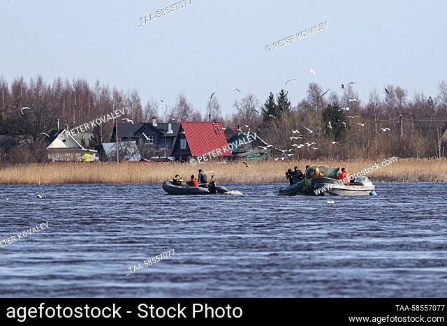 RUSSIA, LENINGRAD REGION - APRIL 21, 2023: Motorboats cruise the Volkhov River fishing for smelt in the town of Novaya Ladoga, 120km east of St Petersburg