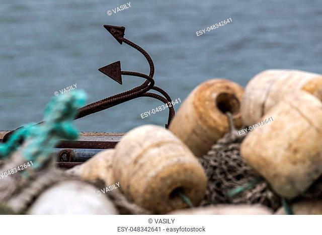 Net with floats and an anchor on the pier