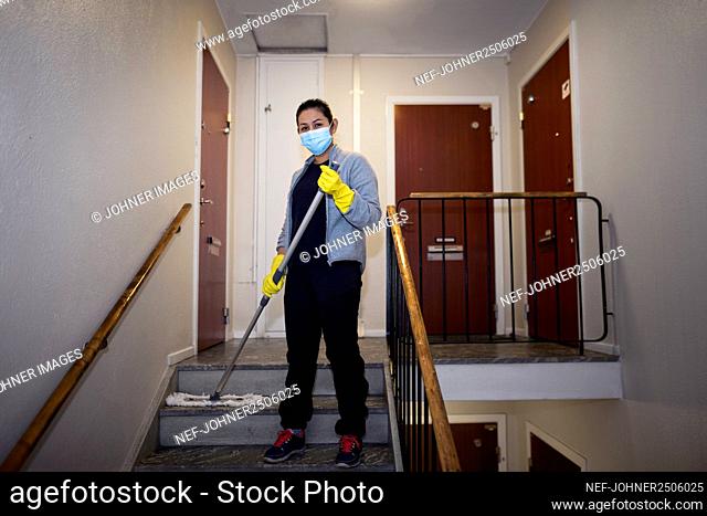 Woman mopping staircase